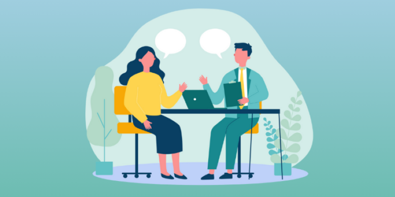 two professionals having a seated coachign conversation