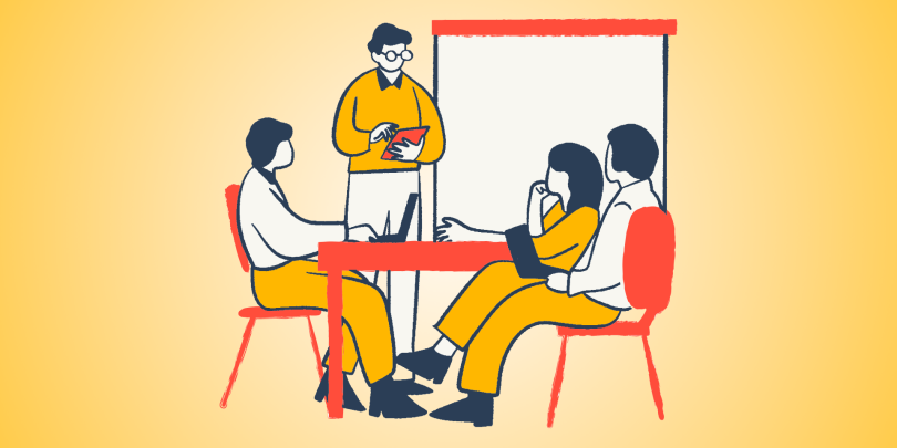 3 people sitting at a table listening to a professional coach