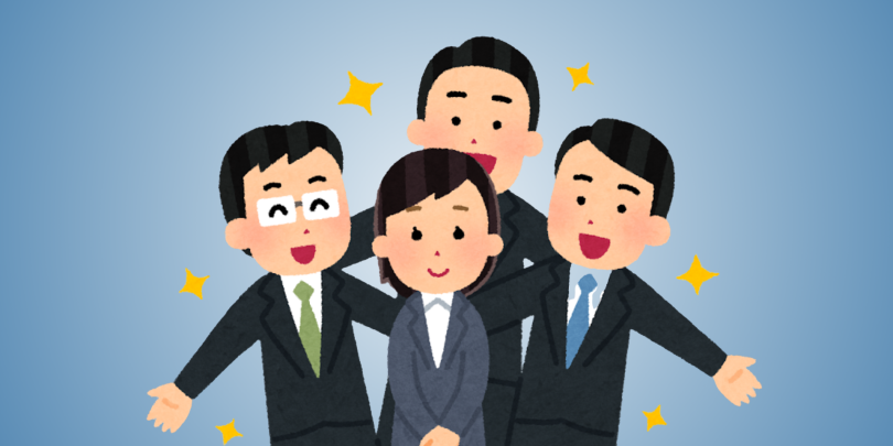 4 employees standing happily together