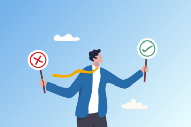 man holding one sign with an X and another sign with a checkmark