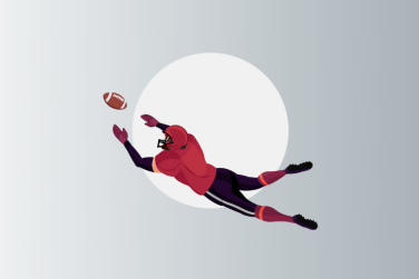 american football player diving to catch ball