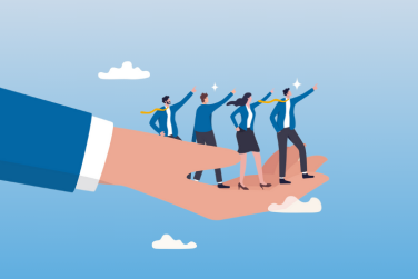 boss' hand holding 4 aspiring employees to represent guiding/helping them