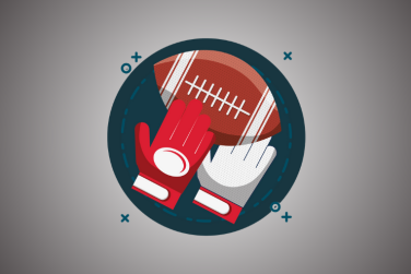 red gloves holding an American football