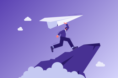 man holding paper airplane on a mountain