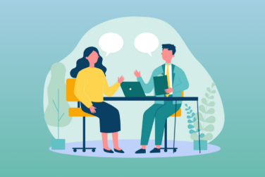two professionals having a seated coachign conversation