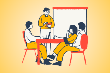 3 people sitting at a table listening to a professional coach