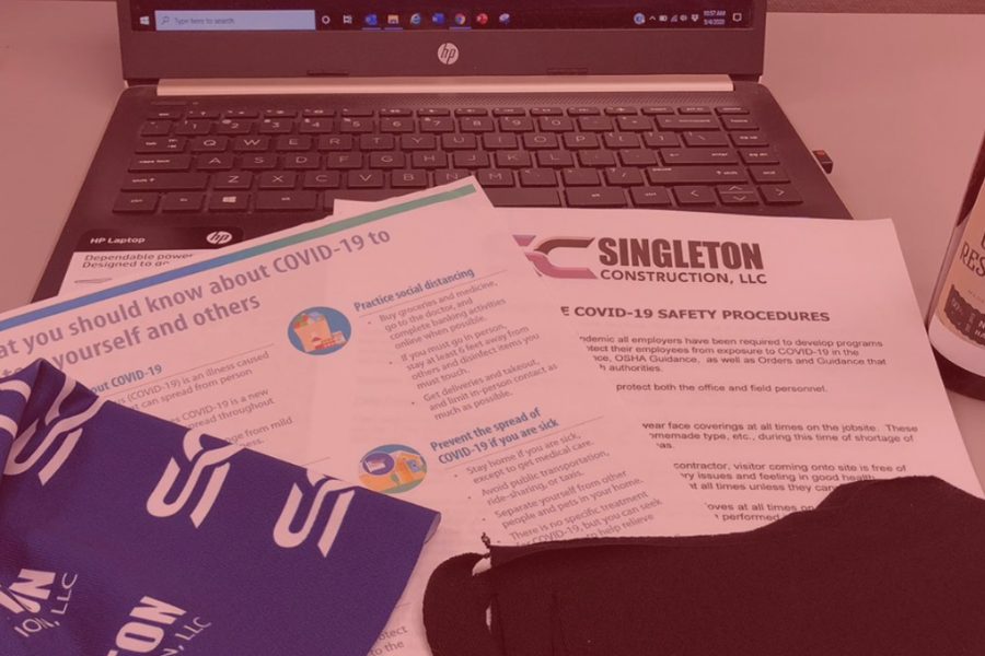 Laptop & papers with Singleton logo and Covid-19 guidelines