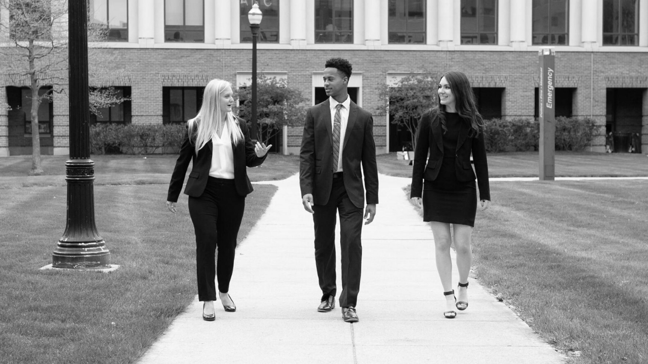 3 Fisher Students Walking Across Campus Dressed in Business Attire