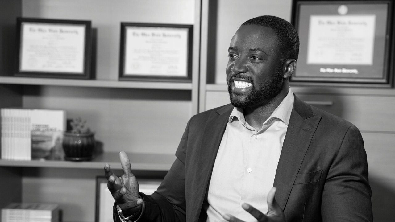 Black and white image of Kwame Christian in his office