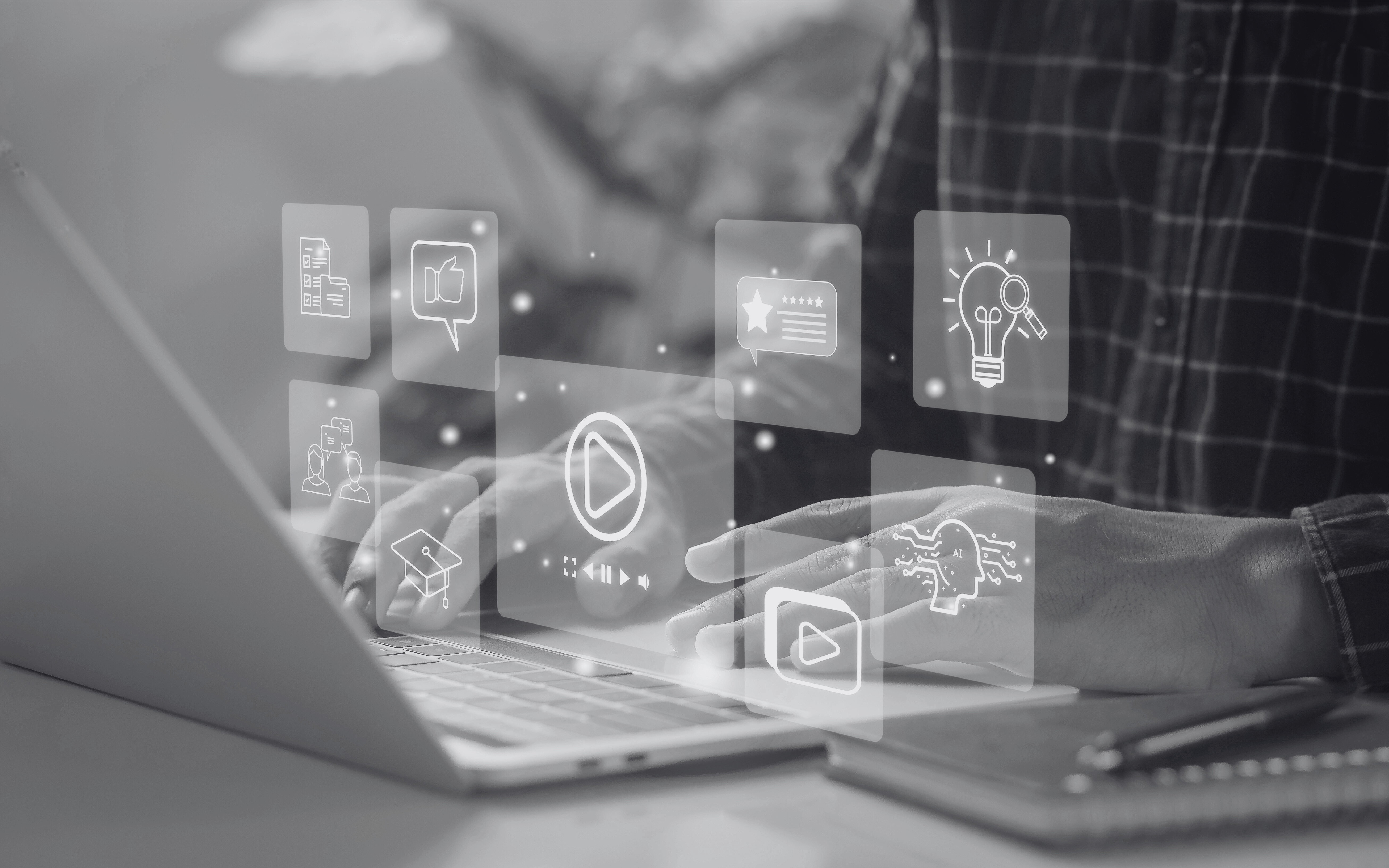 Person sitting at laptop accessing digital content and resources