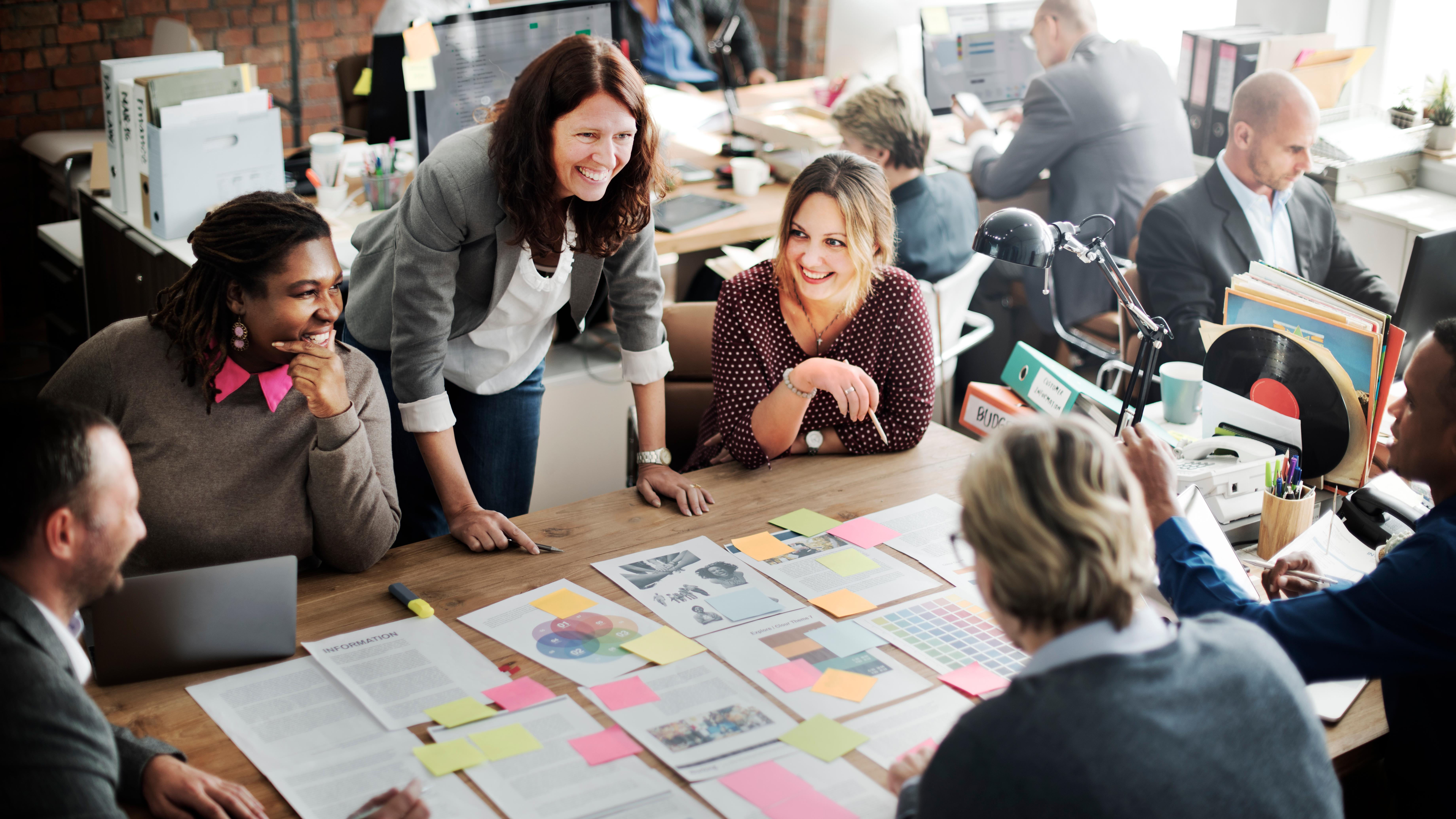 Team seated around table covered in post-it notes