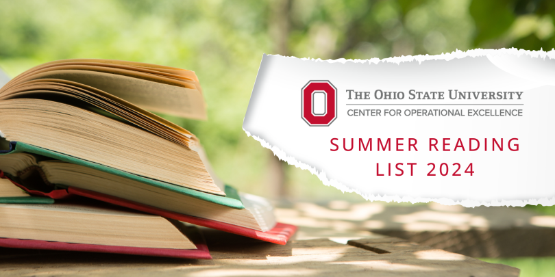 Stack of books open on picnic table on summer day