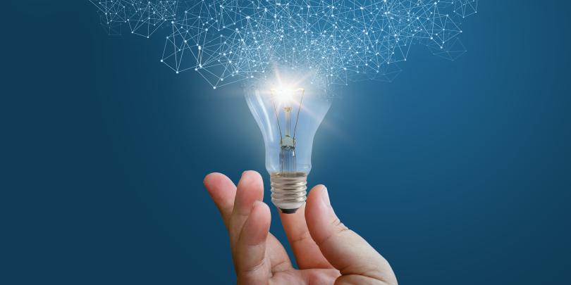 Hand holding lightbulb that represents ideation