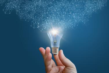 Hand holding lightbulb that represents ideation