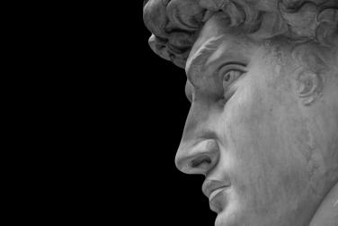 Side profile of marble sculpture with black background