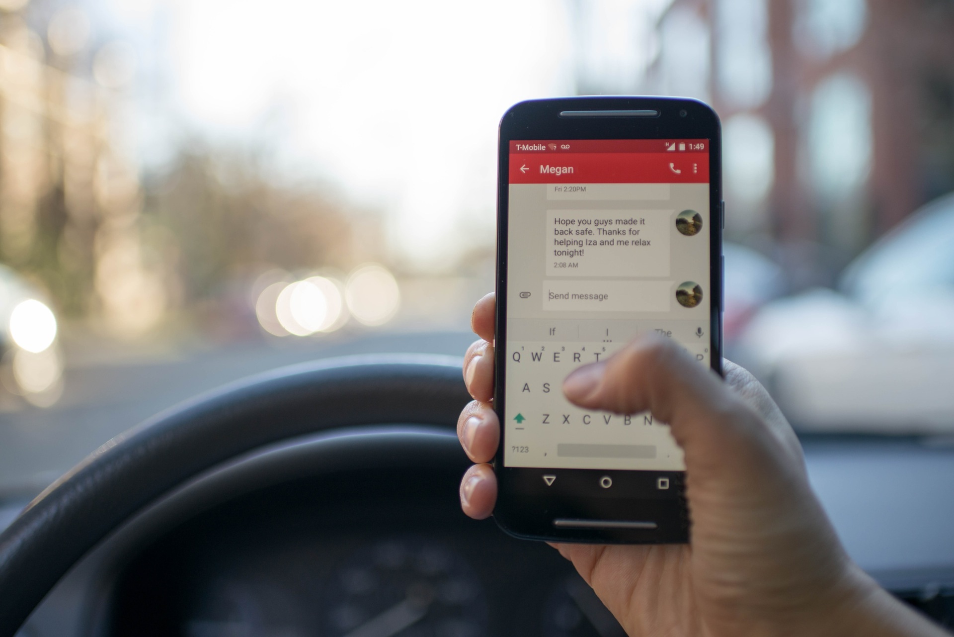 Driver holding a cell phone in a car