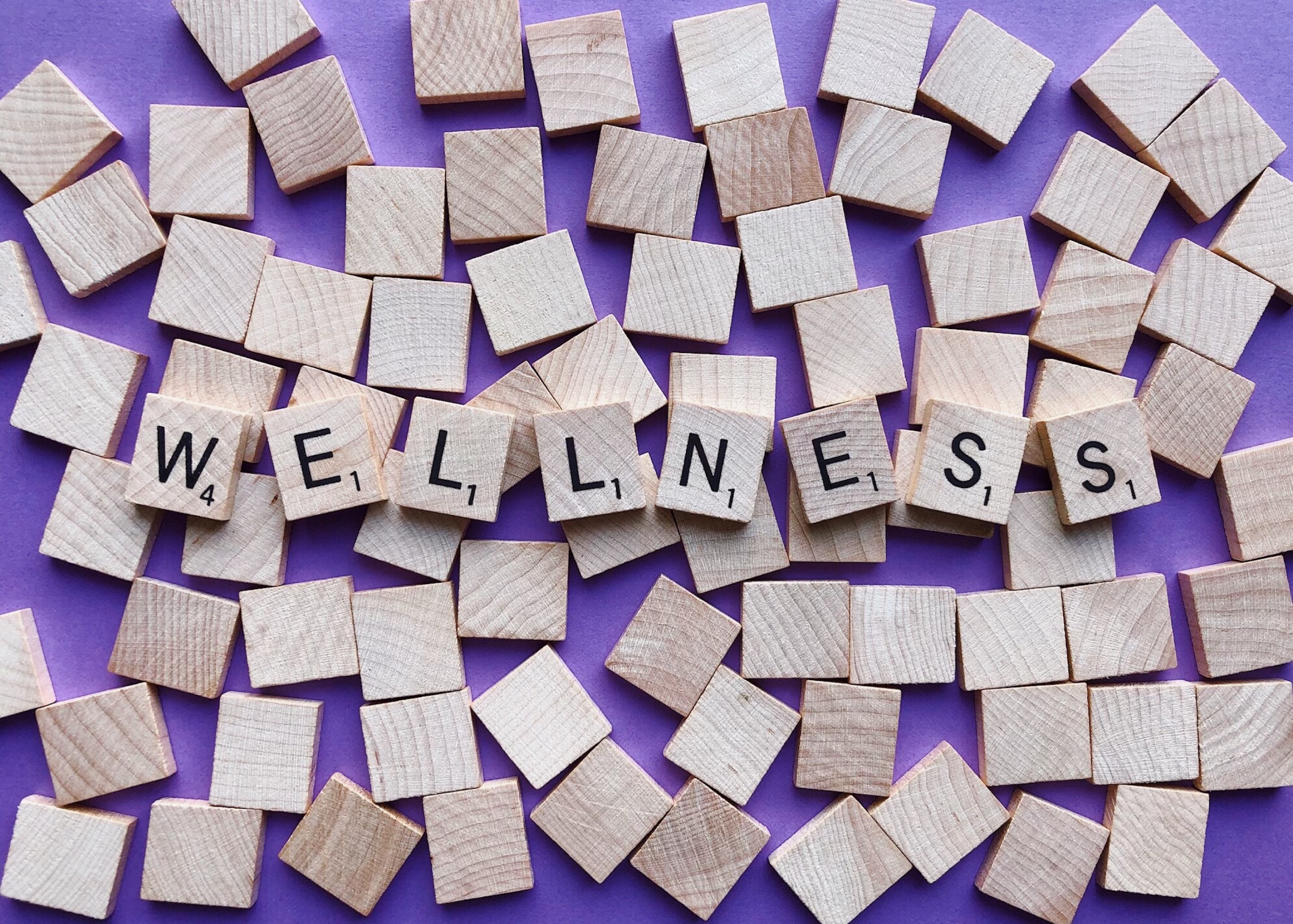 Stock image of Scrabble tiles spelling Wellness