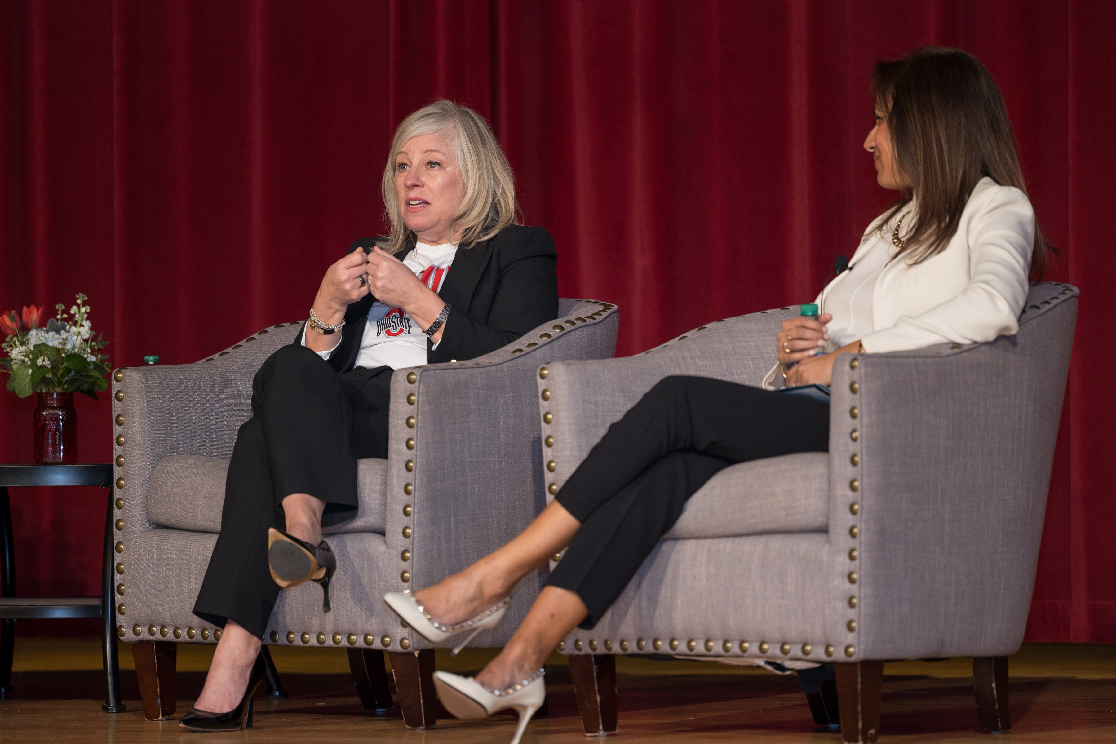 Marna Ricker, seated left, speaks to an audience during the 2024 Women's Leadership Symposium.