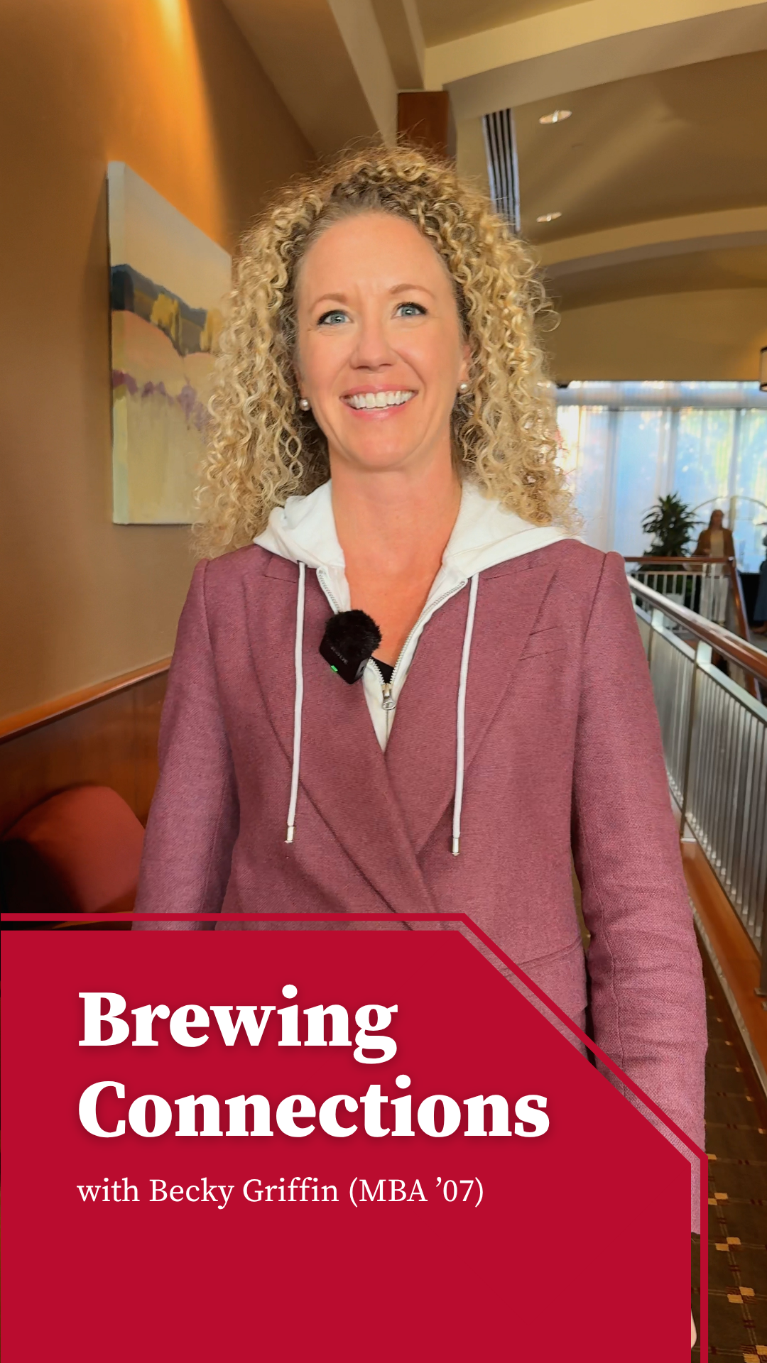 Becky Griffin in lobby holding a coffee cup