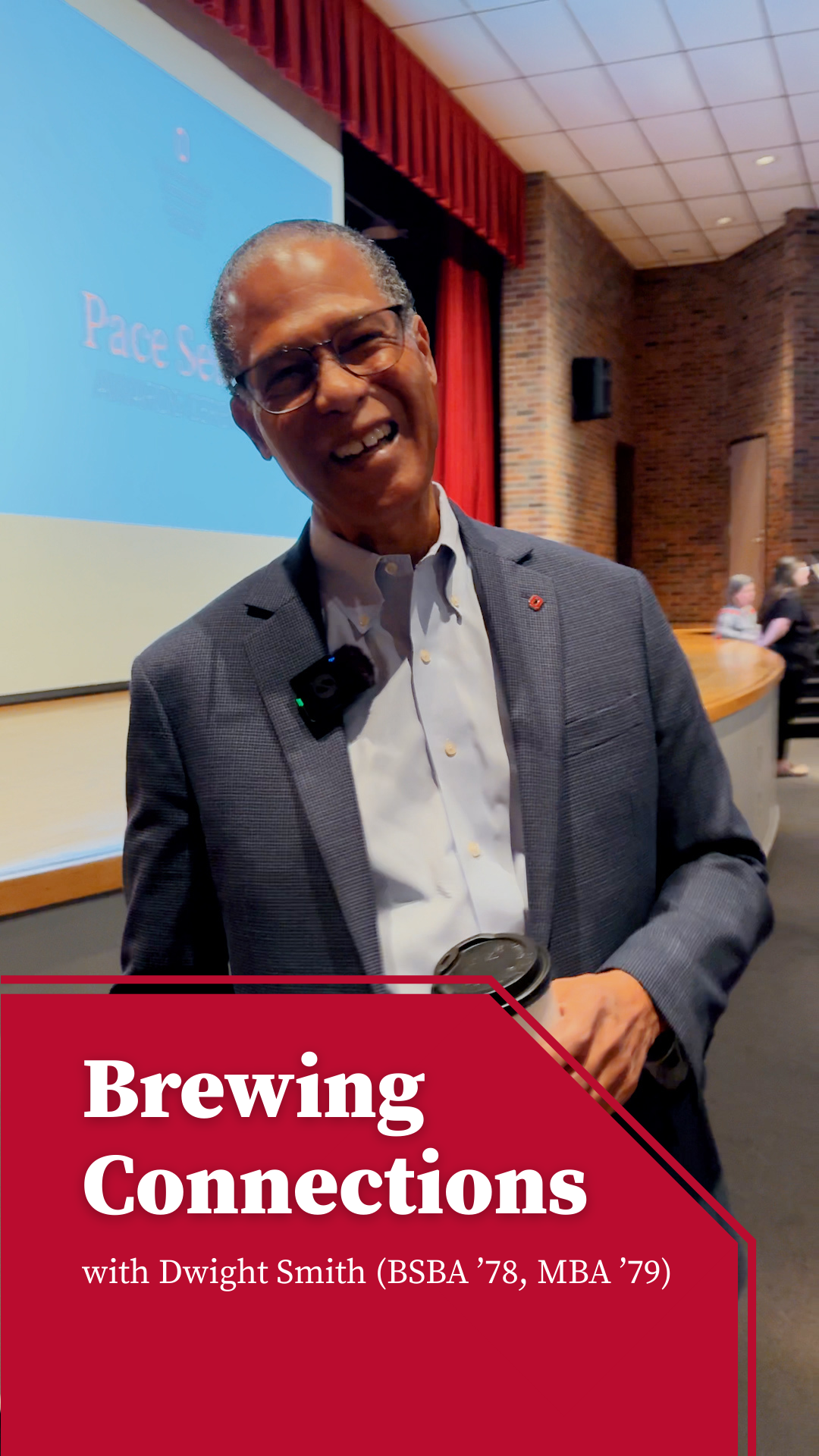 Dwight Smith smiling and hold a cup of coffee.