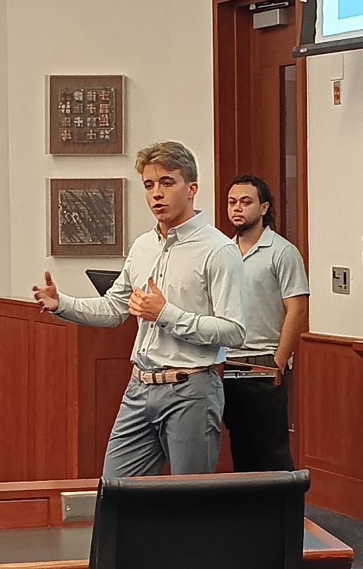 Students in front of classroom giving presentation