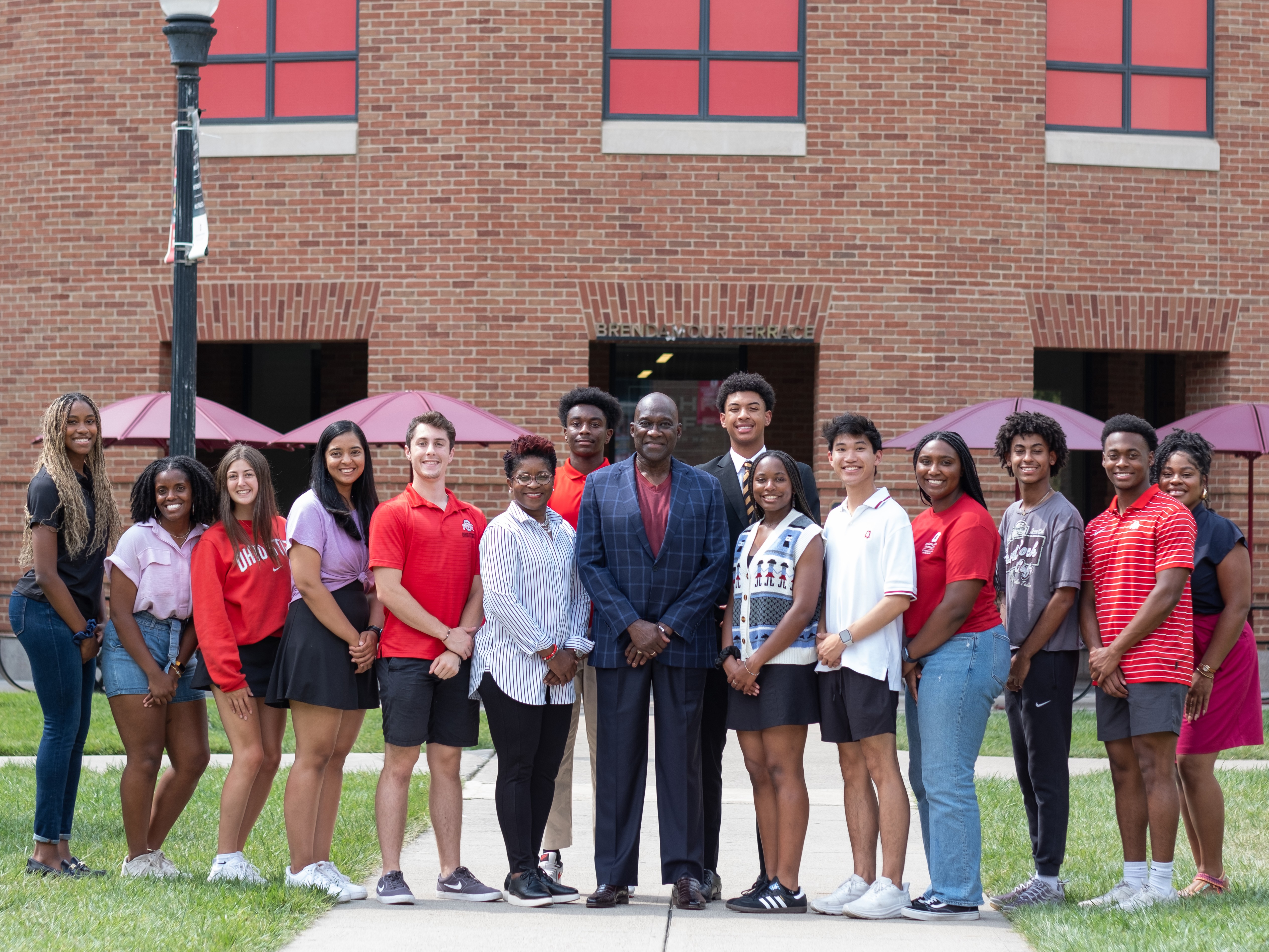 Students pose with Jesse Tyson outside on Fisher's campus.
