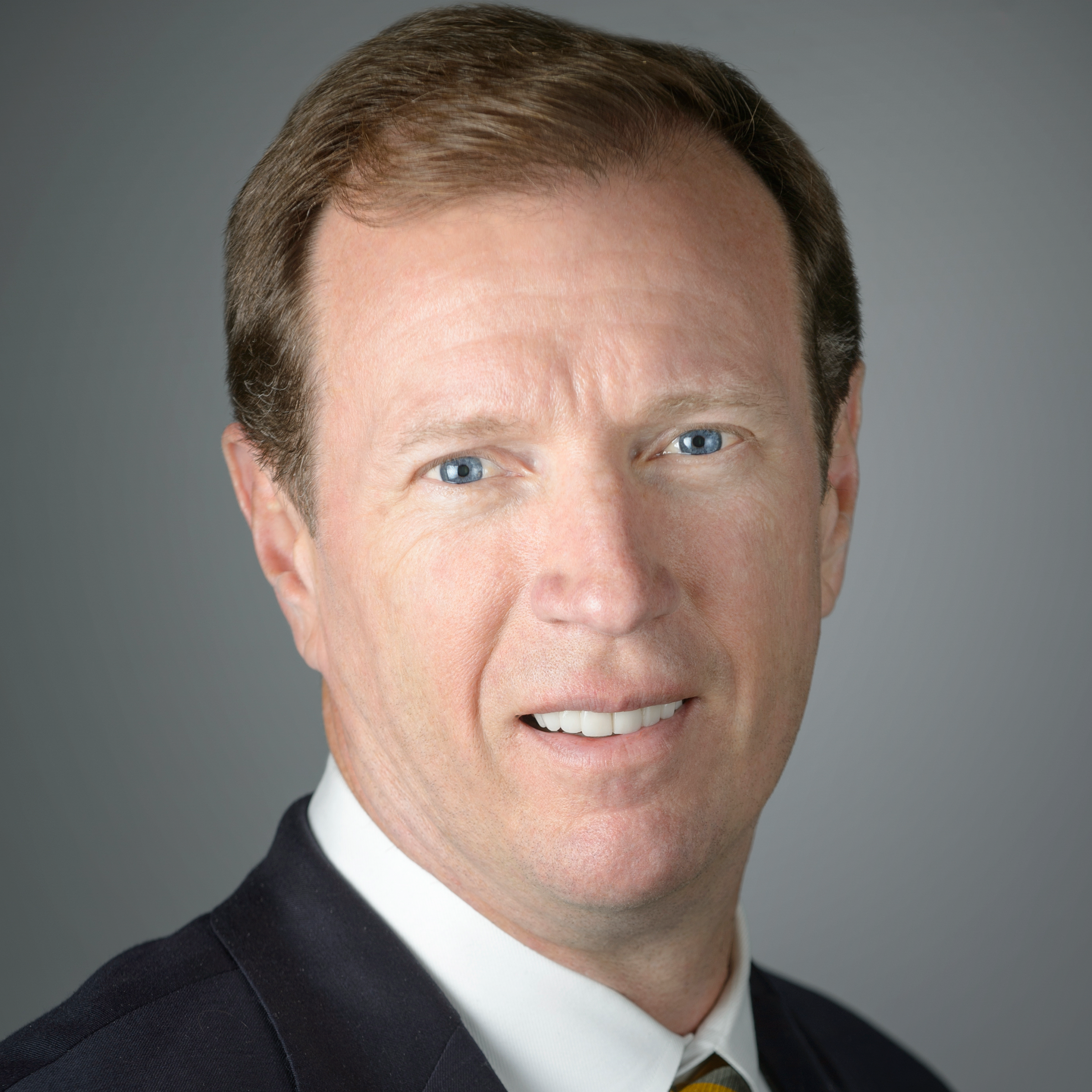 Headshot of Steven Trulaske in dark suit and white shirt..