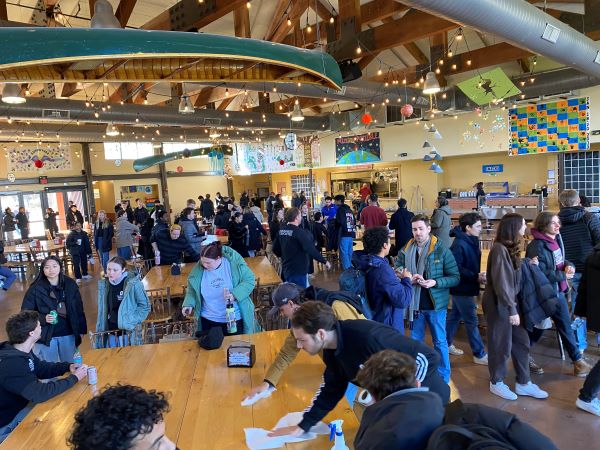 students inside cafeteria cleaning tables