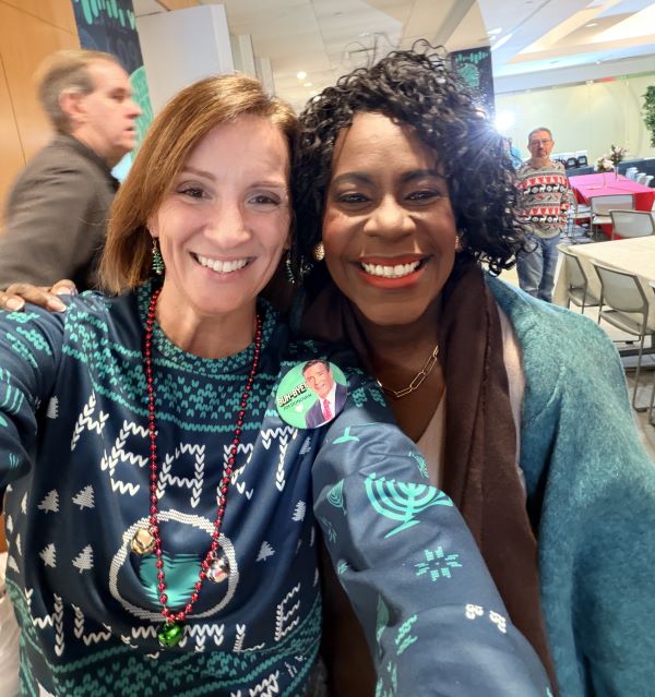 Two women taking a self at a station event.