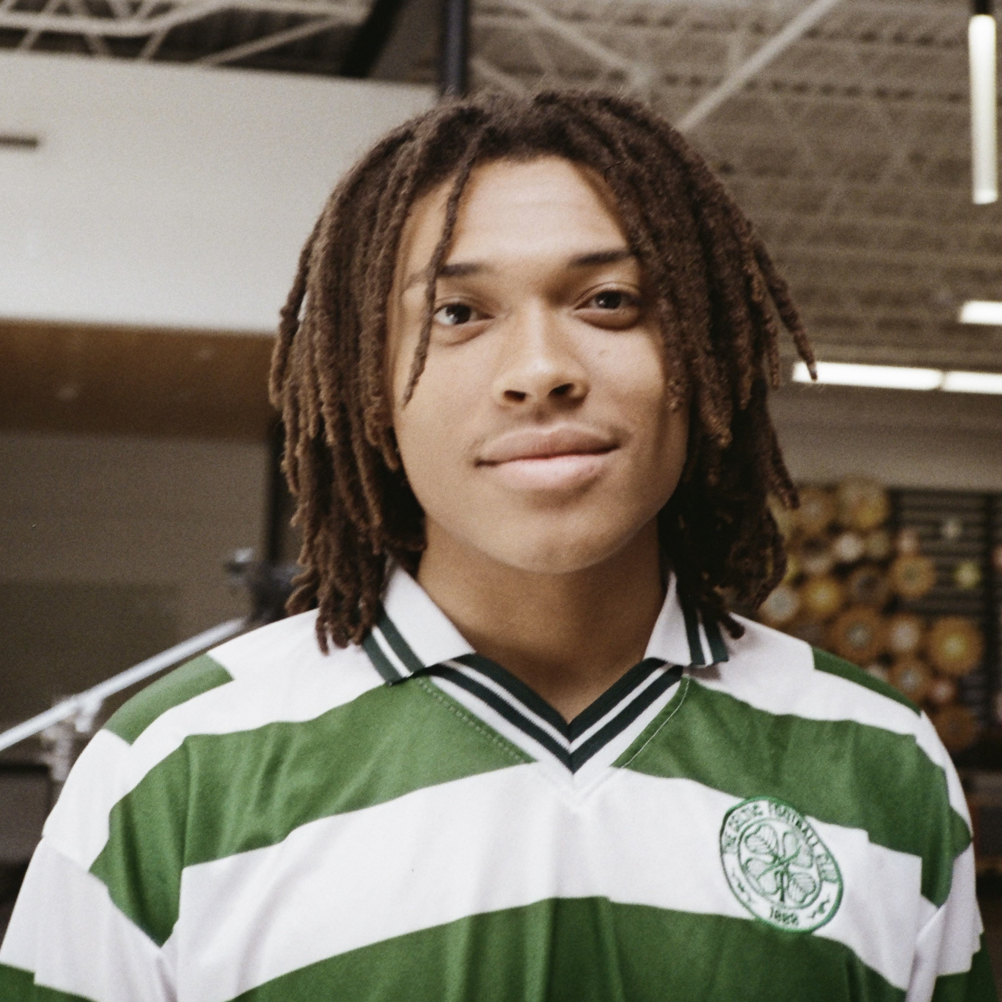 Headhot of Logan St. Hilaire wearing a green and white striped shirt.