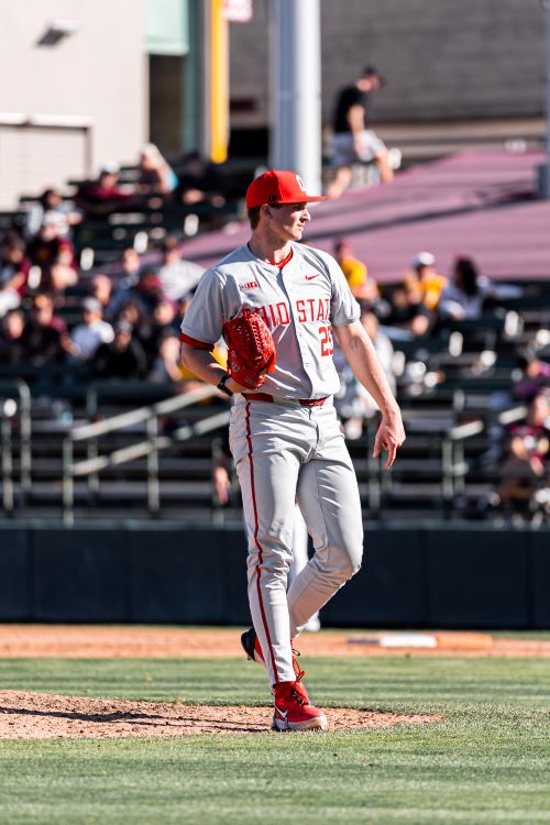 Luke Carrell in his gray Ohio State baseball uniform on the mound after a pitch