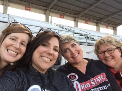 Kathleen and three smiling friends enjoy time together