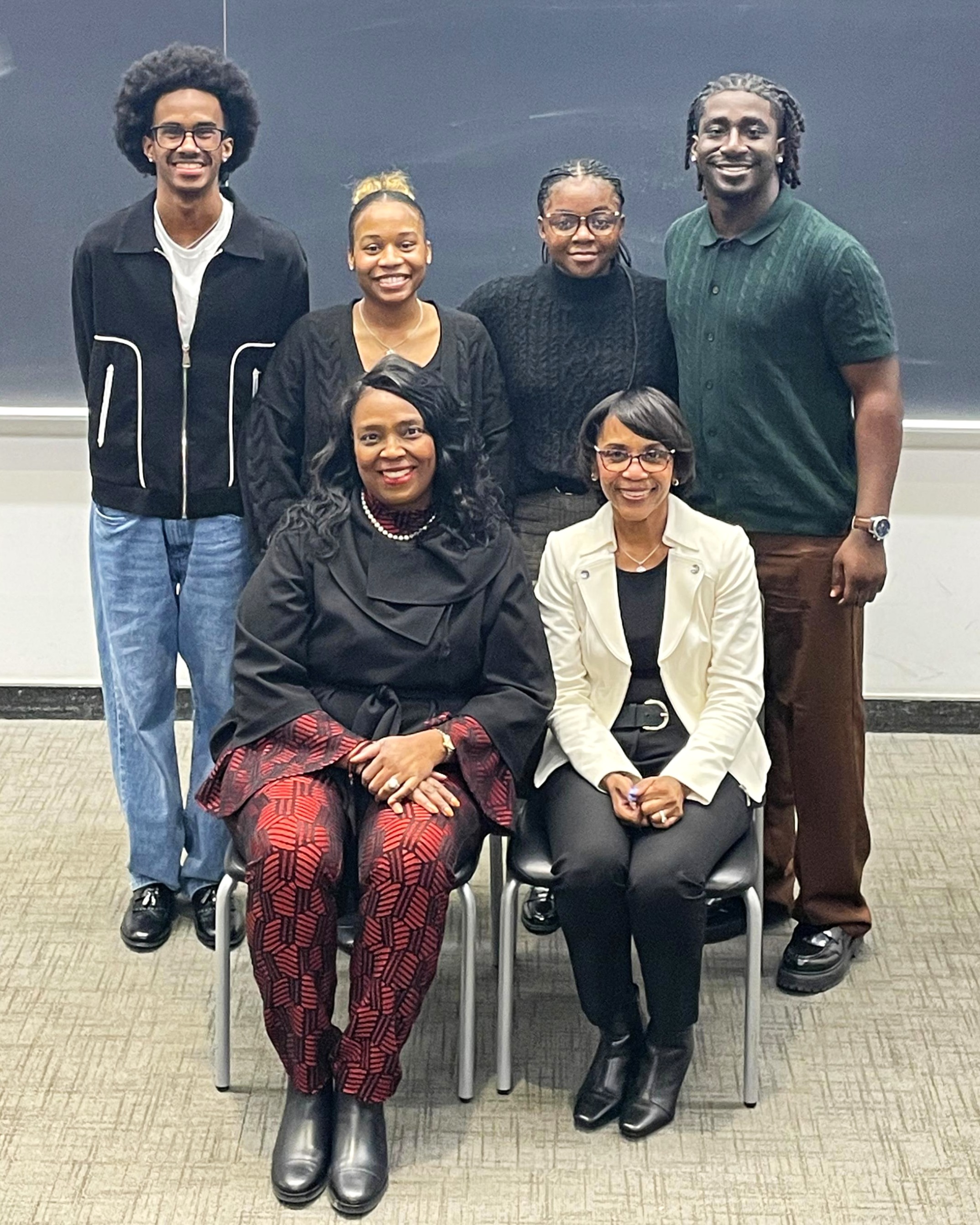Terina Matthews-Davis, left, and Mae Smitherman-Smith, right, are seated in front of student members of the Council of Black Students in Administration.