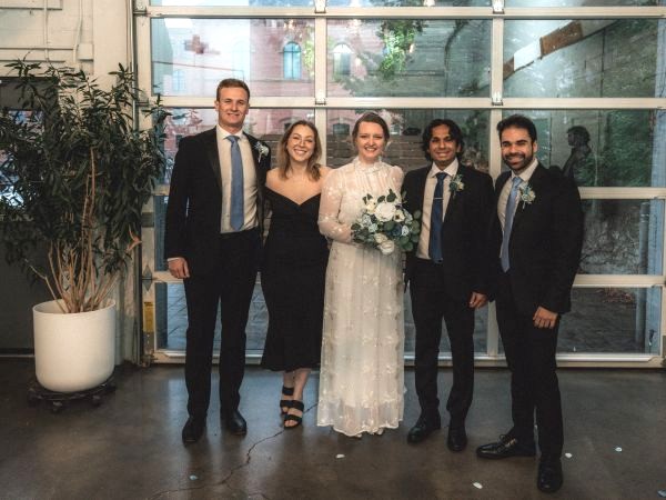 Wedding party dressed up standing in front of garage door with windows
