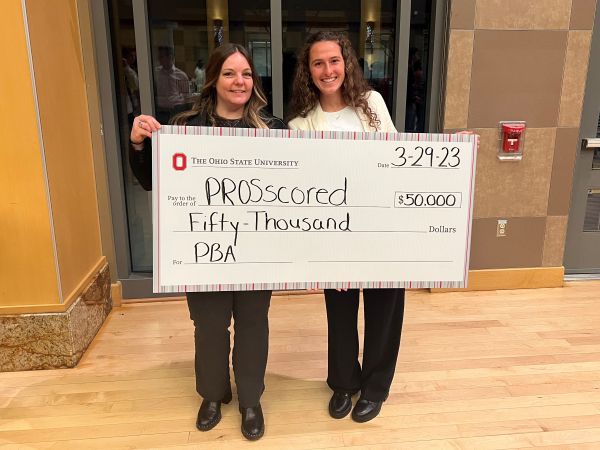 Two women holding up large Ohio State check for $50,000
