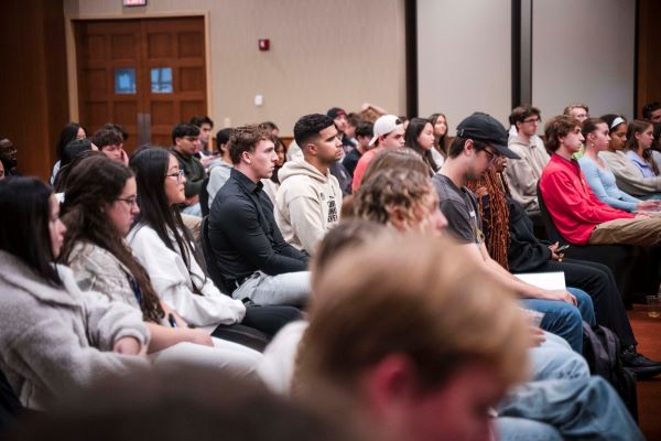 group of students in ballroom listening to Becky Griffin