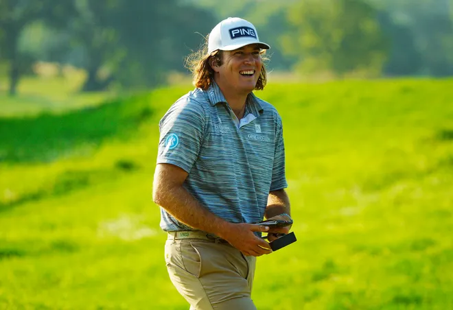 Golfer Neal Shipley smiles while walking the course during a round.