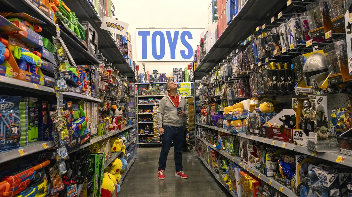 A man looks lost in a toy aisle.