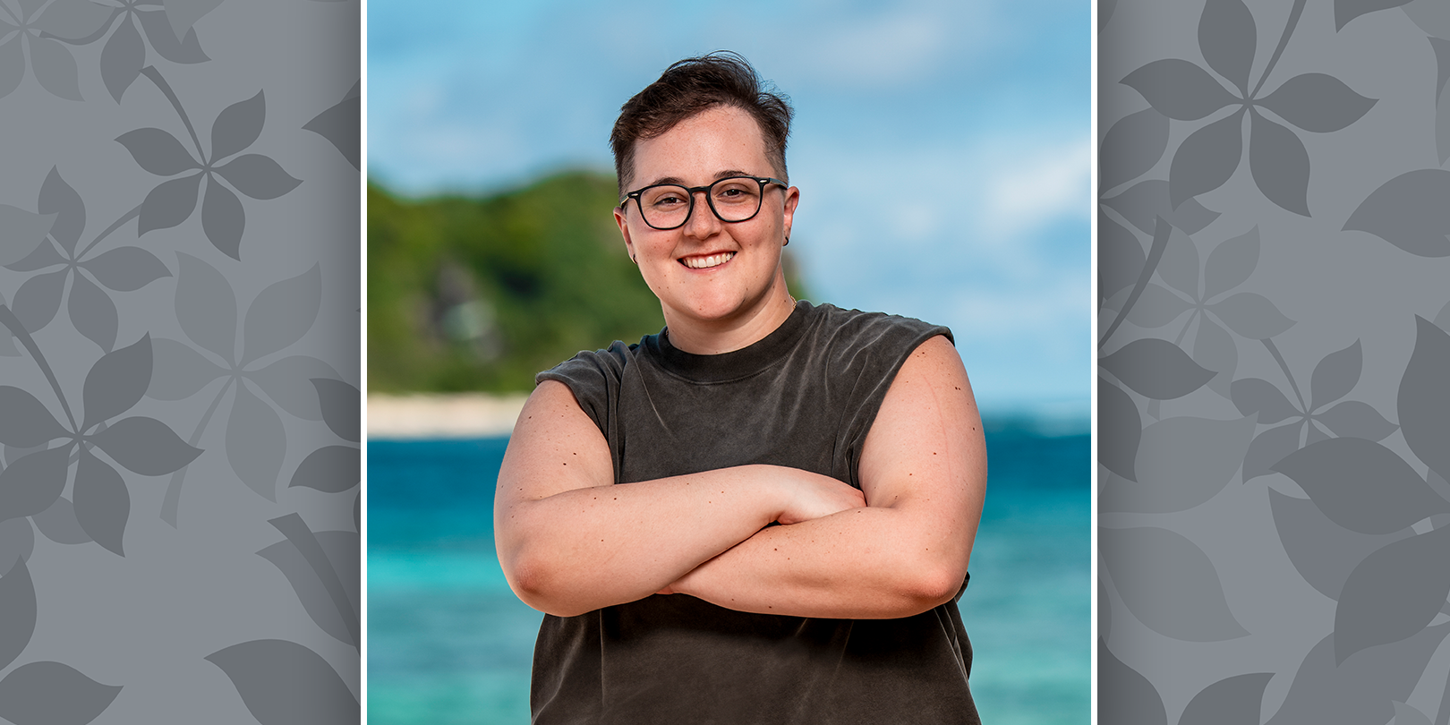 Nicole Mazullo posing with arms crossed and the ocean behind her.