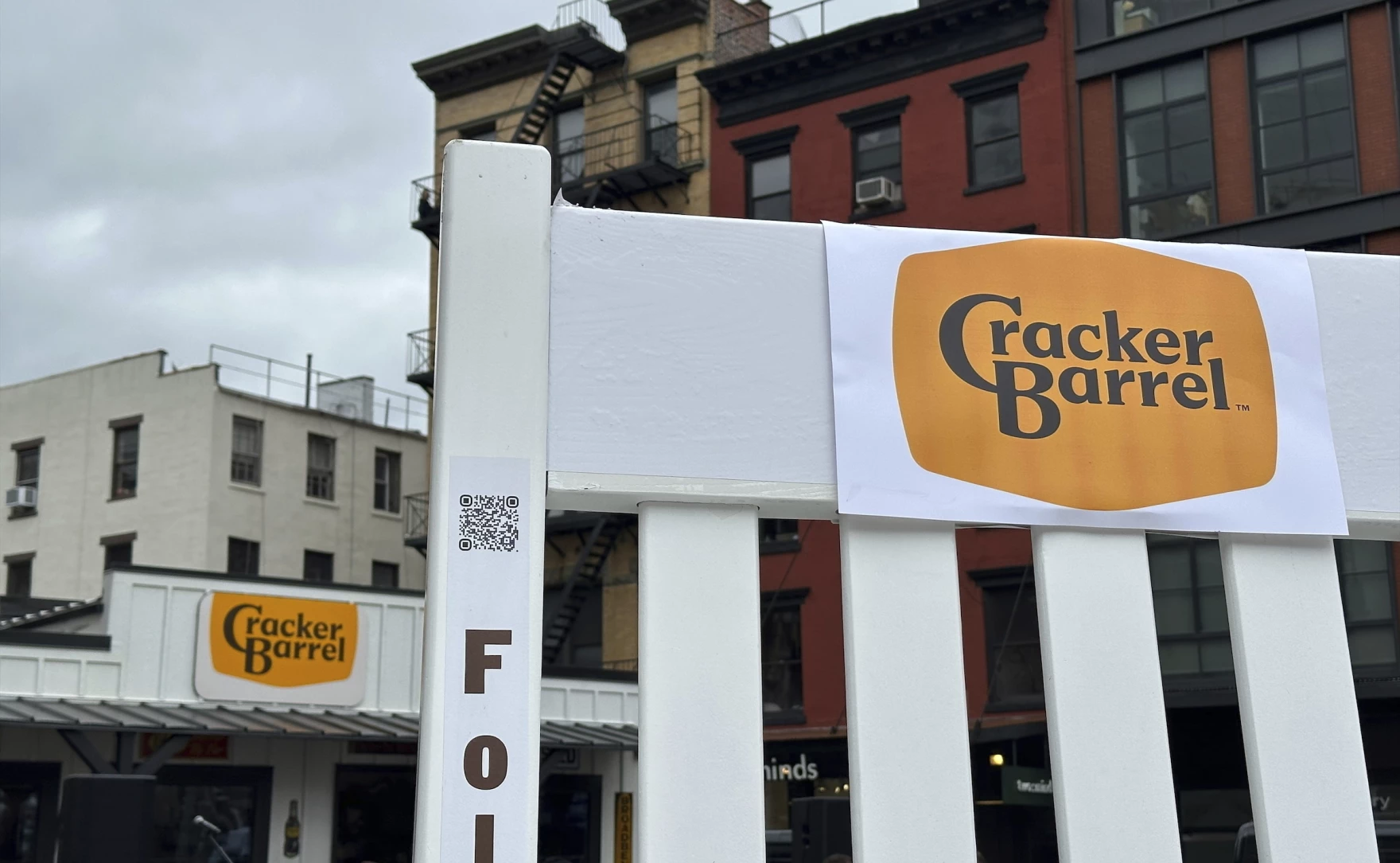 A new Cracker Barrel logo is shown on a sign outside a restaurant.