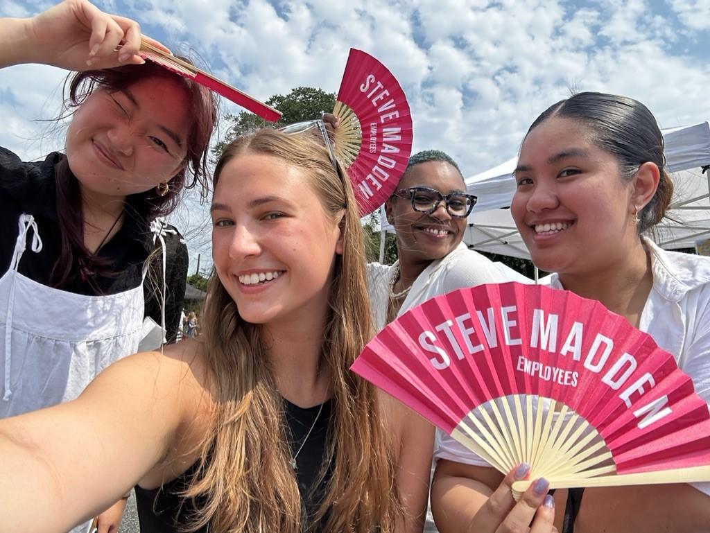 Group of four women, including Olivia Tyka, holding Steve Madden fans