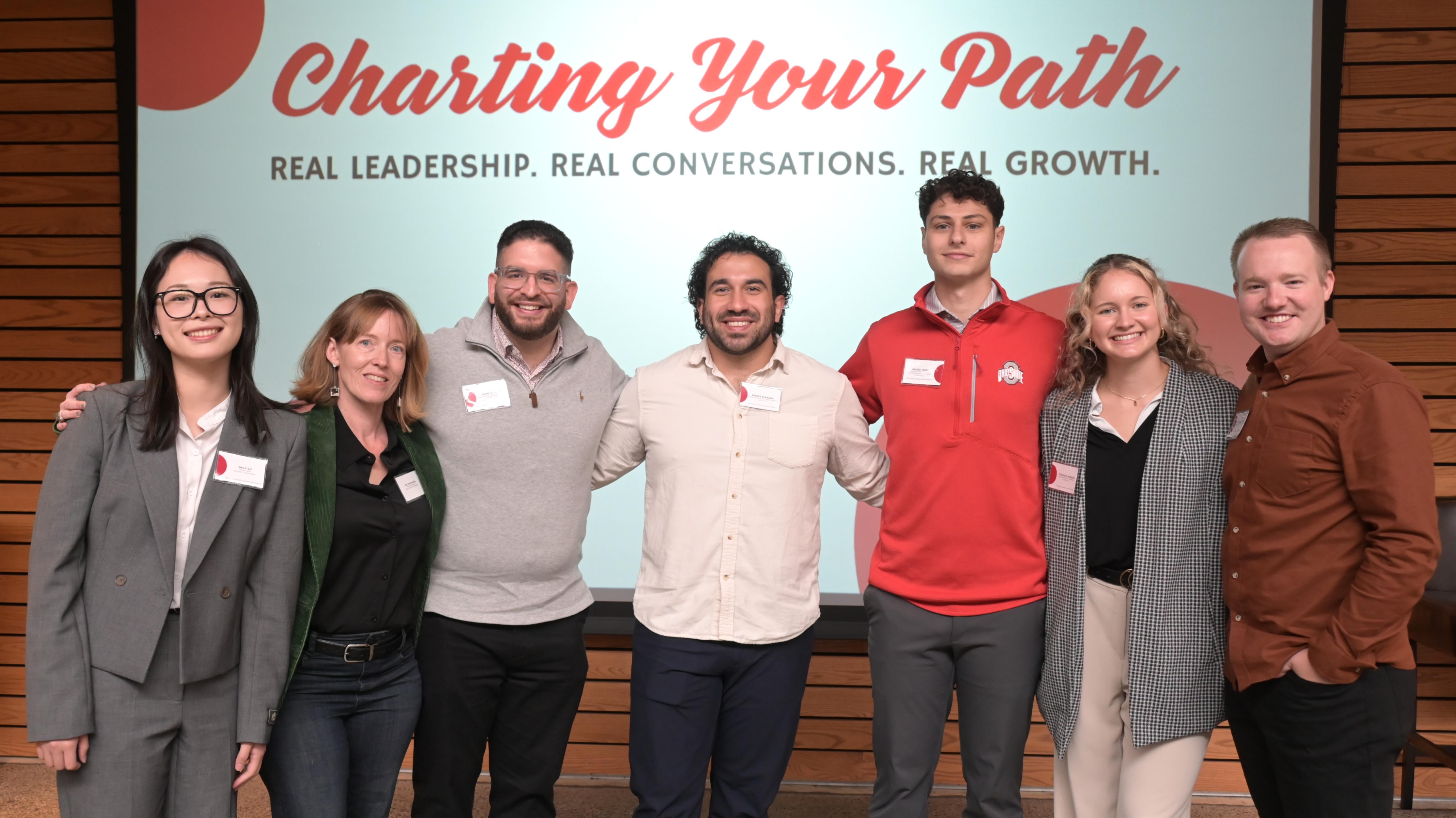 Members of the Deans Leadership Acadamy Alumni Network Board pose in front of a sign that says Charting Your Path.