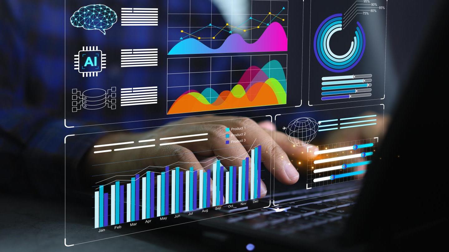 close up of hands typing at a computer with data on the screen
