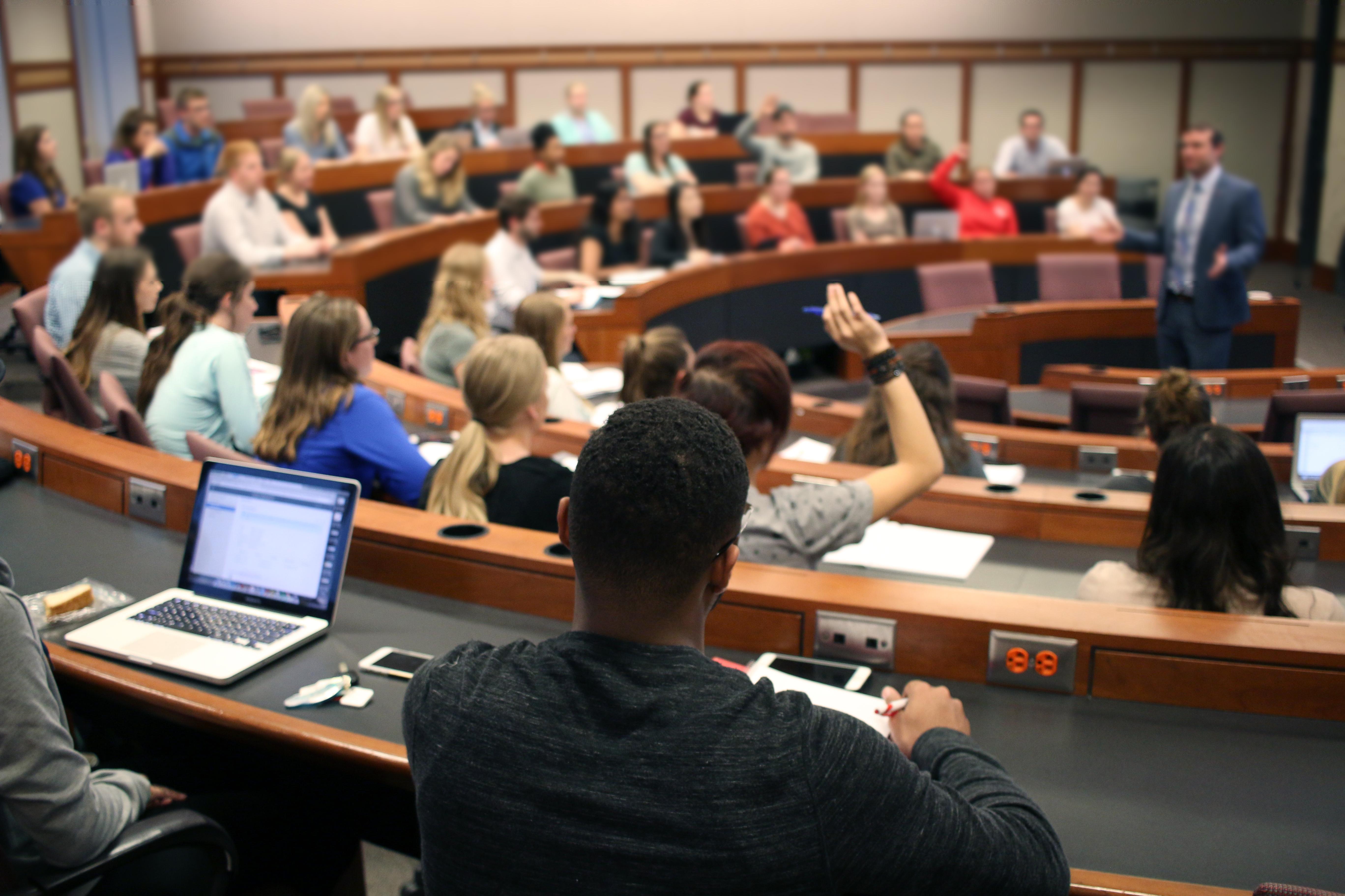 Back of classroom view of students listening to lecture