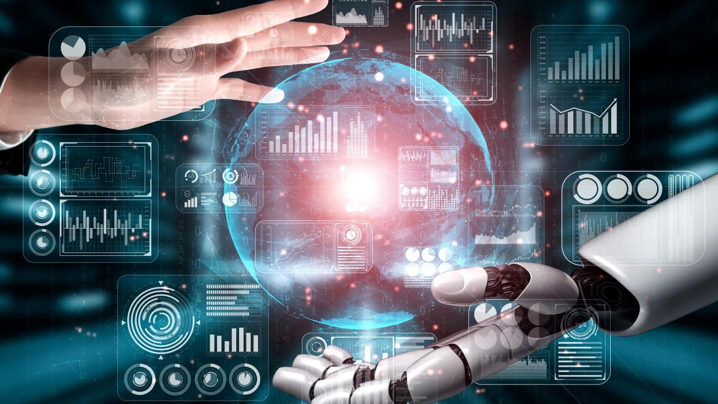 human hand and robot hand with data graphics between