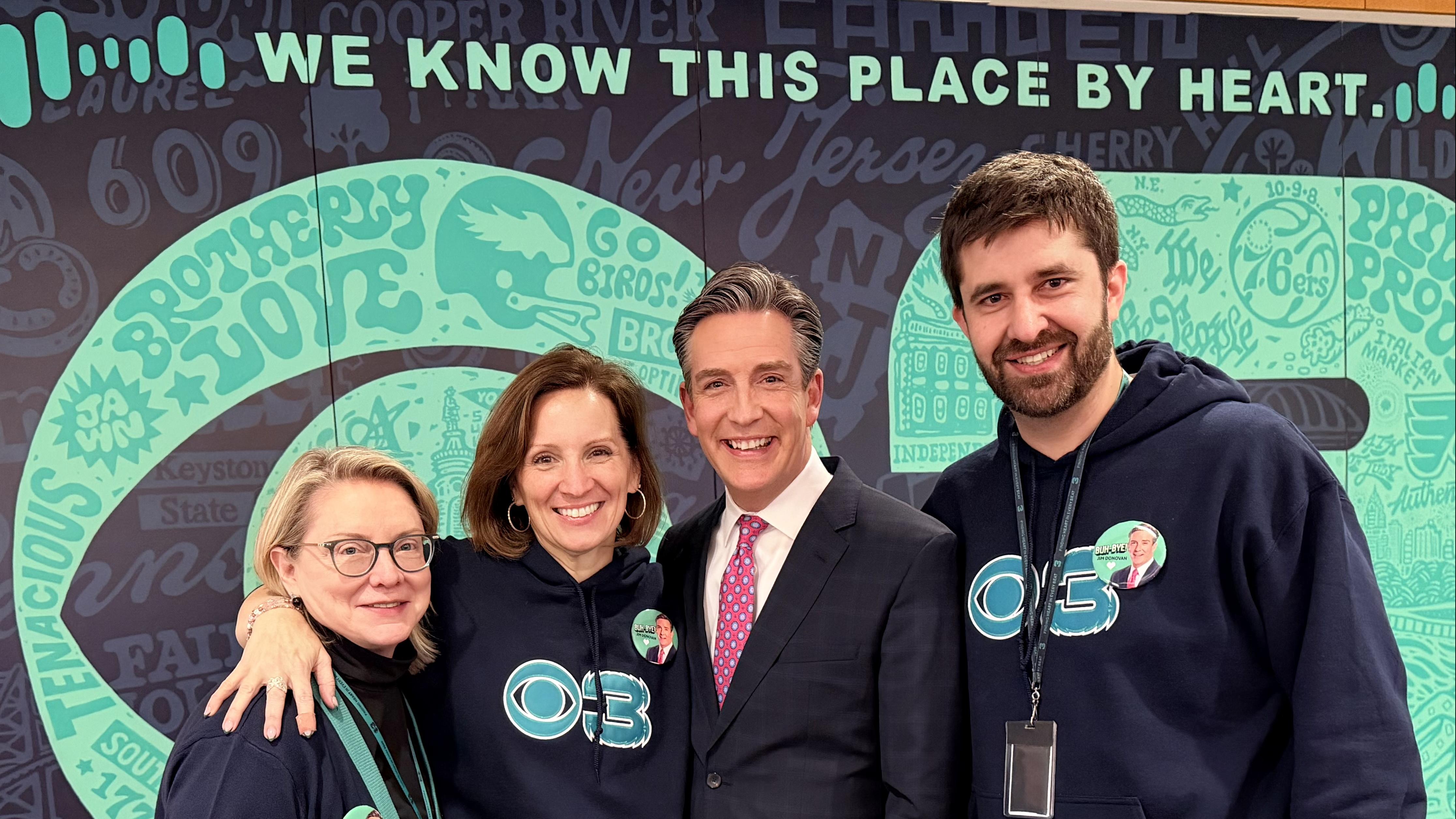 Group of two women and two men in CBS studio with CBS 3 and "We know this place by heart" in background