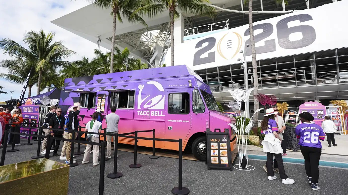 Fans visit the Taco Bell truck before a college football championship.