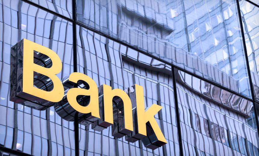 The word Bank in yellow letters on the front of a glass building