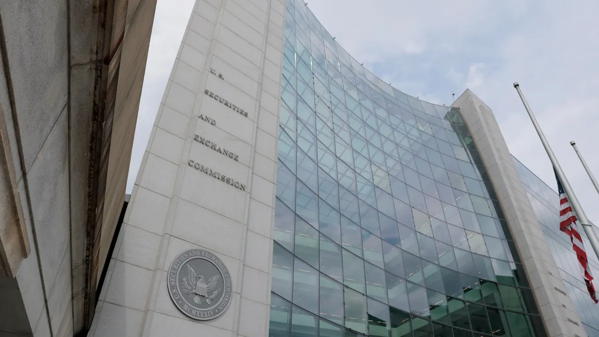 Exterior view of the U.S. Securities and Exchange Commission headquarters, featuring a curved glass façade, SEC seal, and American flag.