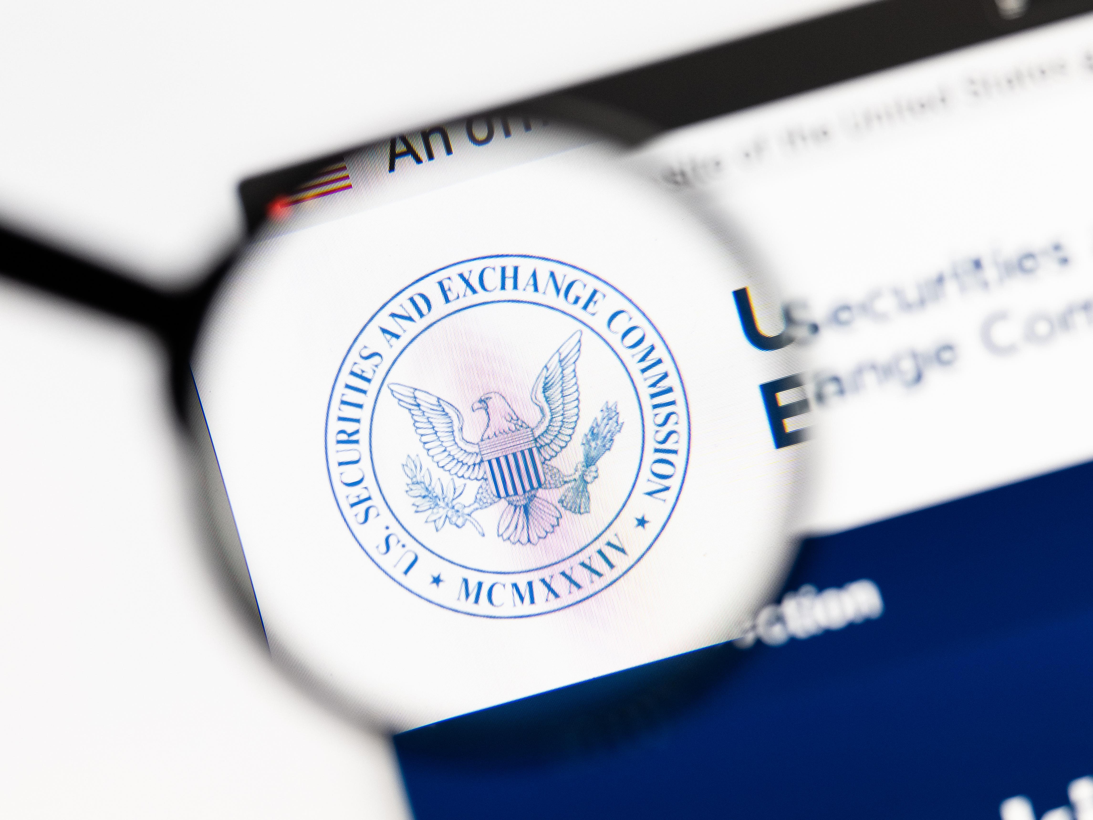 Magnifying glass hovering over the Securities and Exchange Commission logo